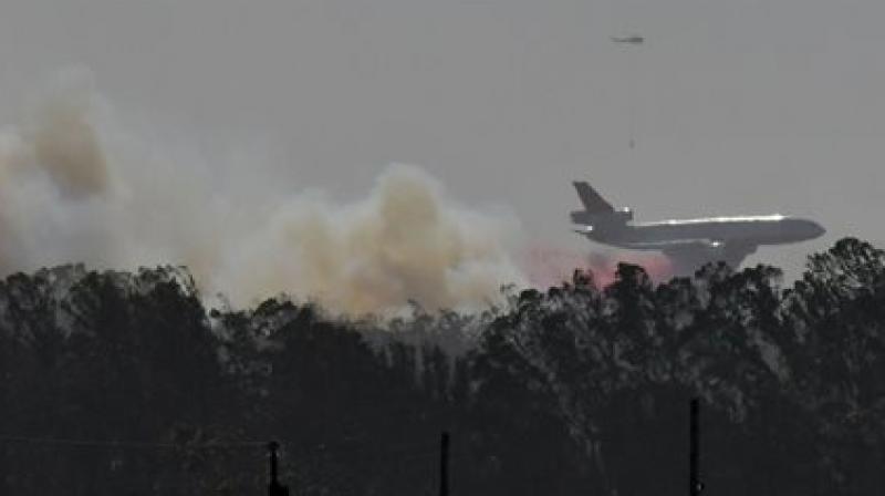 The new blaze which had grown to at least 100 acres brought the evacuation of administrative buildings but was not yet a threat to any of the housing or key facilities on the base