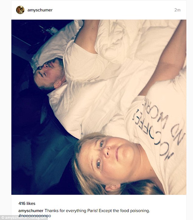 Amy Schumer posts lopsided selfie from bed in Paris and complains of food poisoning