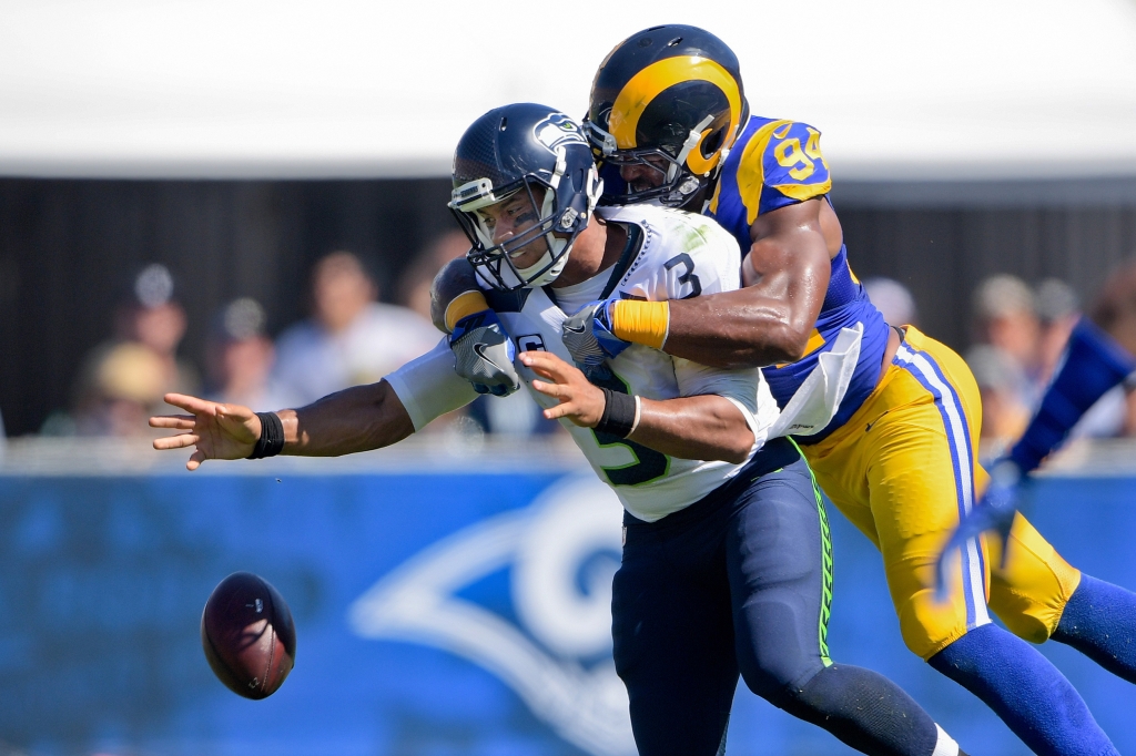 Sep 18 2016 Los Angeles CA USA Seattle Seahawks quarterback Russell Wilson looses the ball as he is sacked by Los Angeles Rams defensive end Robert Quinn during the first half of a NFL game against the Seattle Seahawks at Los Angeles Memoria