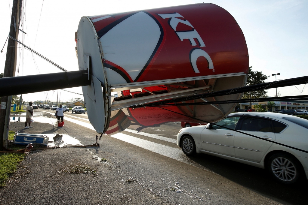 A Kentucky Fried Chicken sign blocks the road in Nassau Bahamas after being toppled by Hurricane Matthew Oct. 7 2016. REUTERS  Carlo Allegri