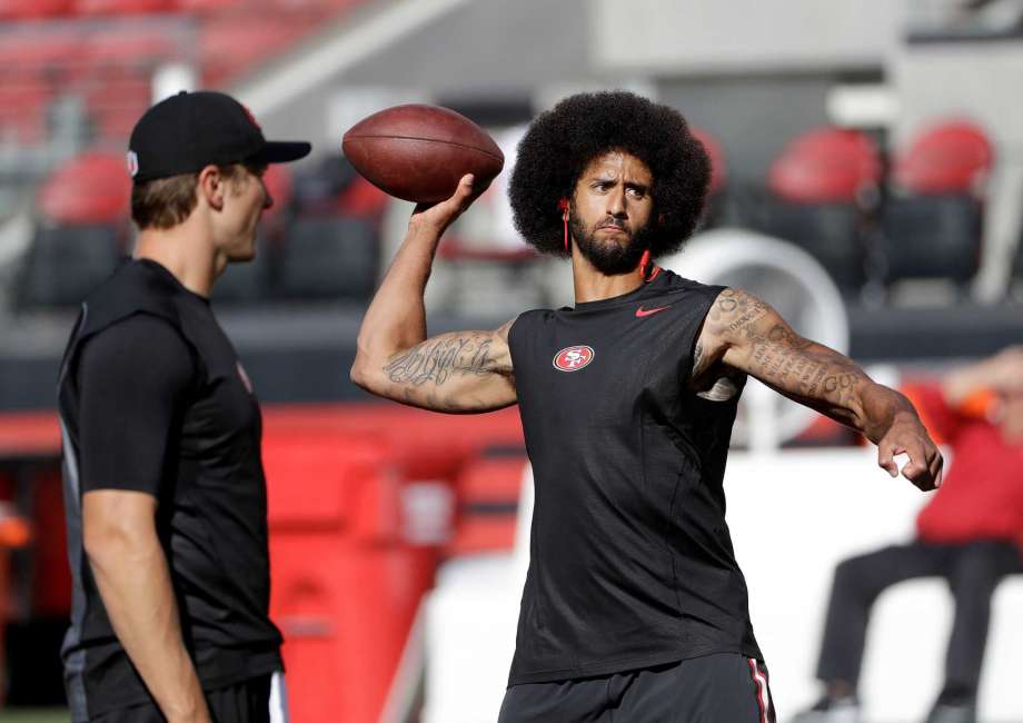 San Francisco 49ers quarterback Blaine Gabbert left watches as quarterback Colin Kaepernick warms up before an NFL football game against the Arizona Cardinals in Santa Clara Calif. Kaepernick will start at quart