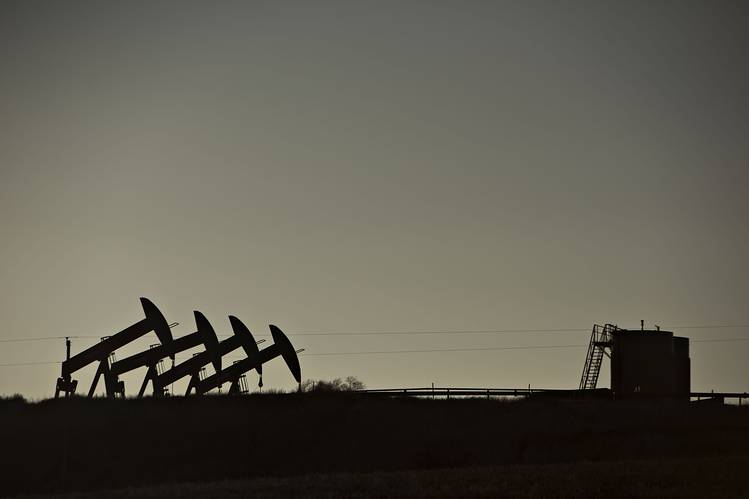 Pumpjacks near Williston North Dakota. Oil prices pulled back Tuesday after the monthly report from the Paris-based International Energy Agency said global supplies rose in September