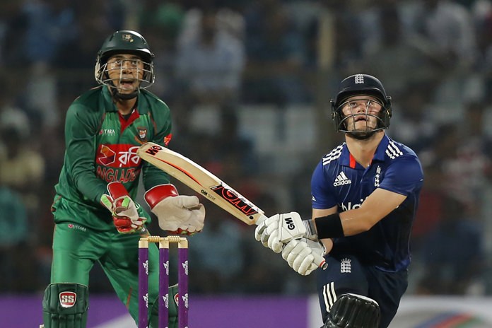 England’s Ben Duckett right plays a shot as Bangladesh's wicketkeeper Mushfiqur watches the ball during the third one-day international cricket match in Chittagong Bangladesh Wednesday Oct. 12