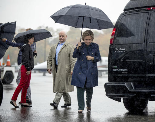 Democratic presidential candidate Hillary Clinton arrives to board her campaign plane at Westchester County Airport in White Plains N.Y. Friday Oct. 21 2016 to travel to Cleveland for a rally