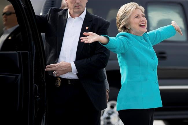 Democratic presidential candidate Hillary Clinton reacts to a reporters questions about her birthday before boarding her campaign plane at Miami International Airport in Miami Wednesday Oct. 26 2016 to travel to Lake Worth Fla. for a rally. Clinton