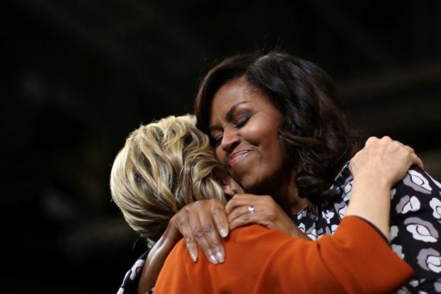 First lady Michelle Obama embraces Democratic presidential candidate Hillary Clinton as they arrive at a campaign rally in Winston-Salem North Carolina