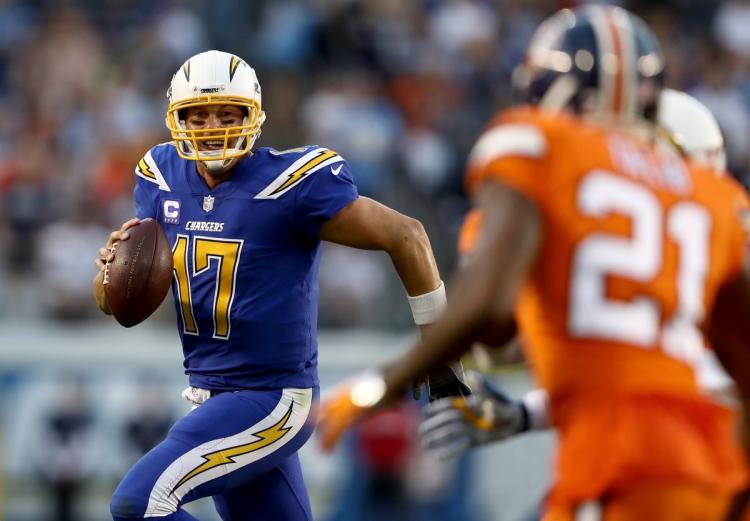 Philip Rivers runs from the pocket during Chargers’ win over Broncos