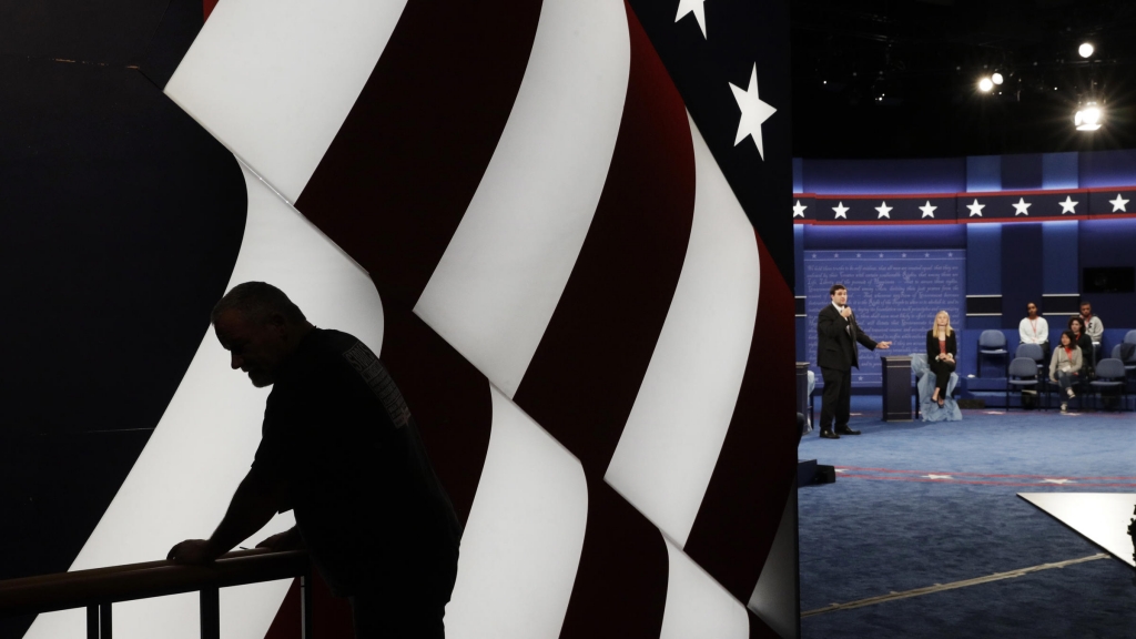 Students stand in on the stage as preparations are made for the second presidential debate at Washington University in St. Louis