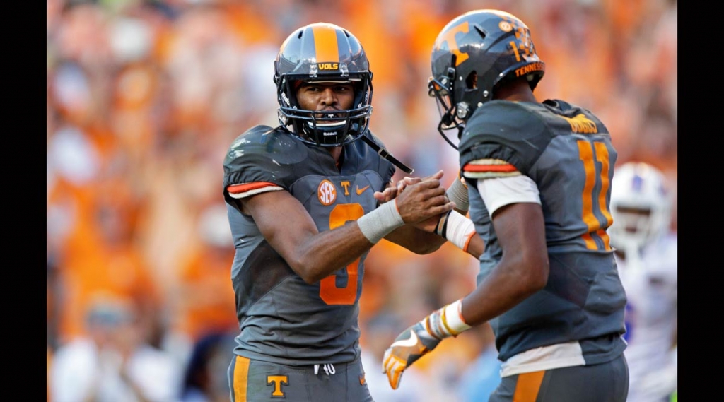 Tennessee wide receiver Josh Malone celebrates with quarterback Joshua Dobbs after the two connected for a touchdown during the second half of an NCAA college football game against Florida Saturday Sept. 24 2016 in Knoxville Tennessee