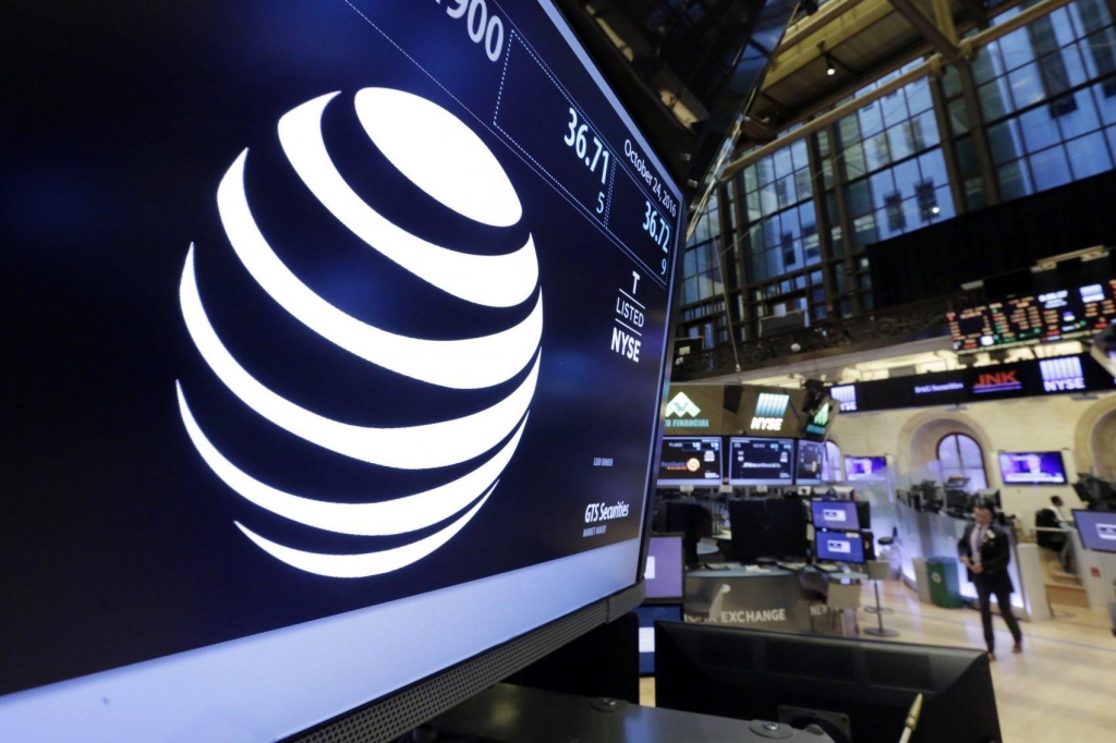 The AT&T logo appears above the post where it trades on the floor of the New York Stock Exchange Monday Oct. 24 2016. AT&T's $85.4 billion purchase of Time Warner represents a new bet on synergy between companies that distribute information and