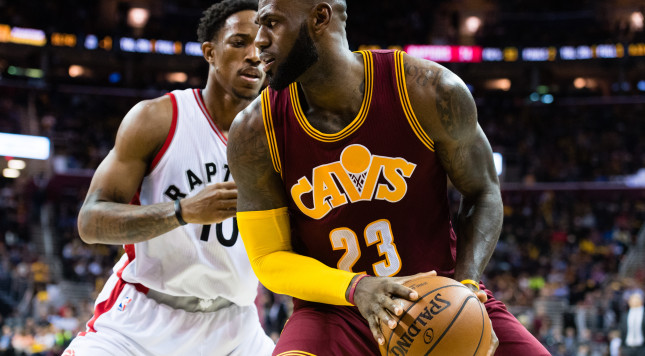 CLEVELAND OH- NOVEMBER 15 Le Bron James #23 of the Cleveland Cavaliers fights for position with De Mar DeRozan #10 of the Toronto Raptors during the second half at Quicken Loans Arena