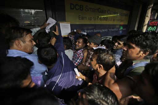 Indians jostle to get inside a bank to deposit and exchange discontinued currency notes in New Delhi India. The sudden withdrawal of 86 percent of India's currency has left cash