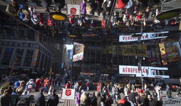 People are reflected in a mirror as they shop during Black Friday sales in New York