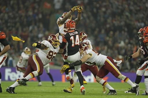 Cincinnati Bengals quarterback Andy Dalton, centre is tackled after managing to throw the ball away during an NFL Football game against Washington Redskins at Wembley Stadium in London Sunday Oct. 30 2016