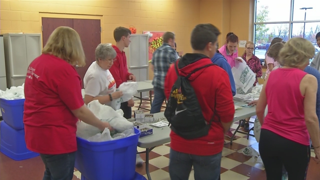 Volunteers stuff race packets ahead of annual Turkey Trot