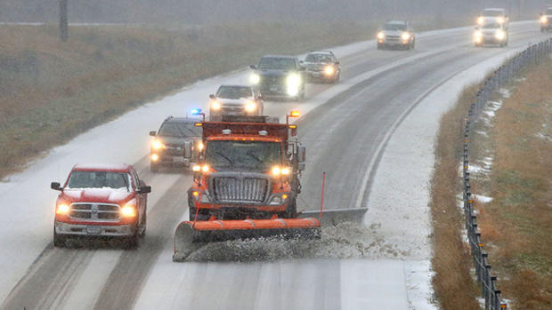 Traffic moves slowly as a plow clears snow and slush off Interstate 35 near Esko on Friday