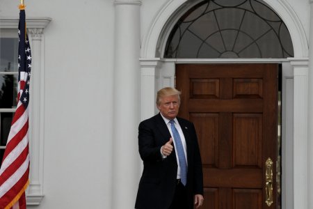 U.S. President-elect Donald Trump gestures from the front door at the main clubhouse at Trump National Golf Club in Bedminster New Jersey U.S