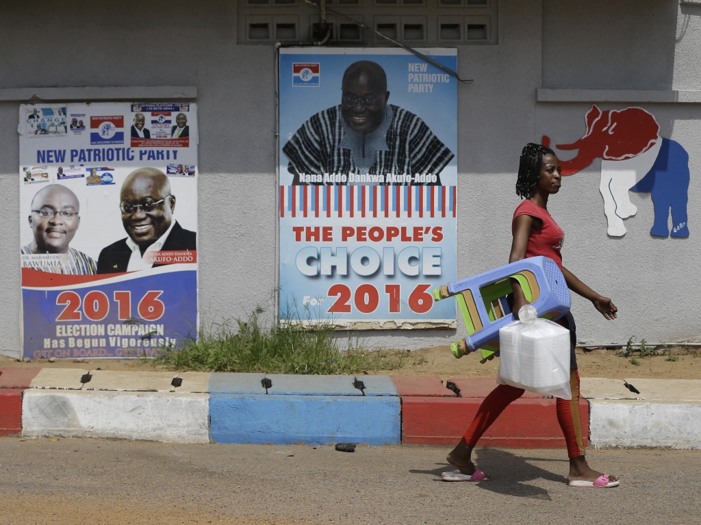 A woman walks past campaign posters of opposition presidential candidate Nana Akufo Addo of the New Patriotic Party on Thursday in Accra Ghana