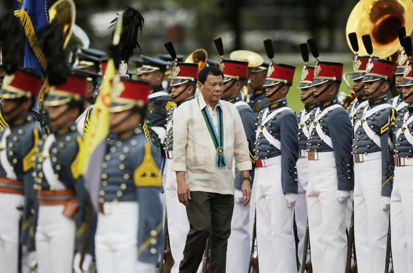 Philippine President Rodrigo Duterte inspects troops during the 81st anniversary of the Armed Forces of the Philippines at Camp Aguinaldo military headquarters in Quezon city north of Manila Philippines on Dec. 21