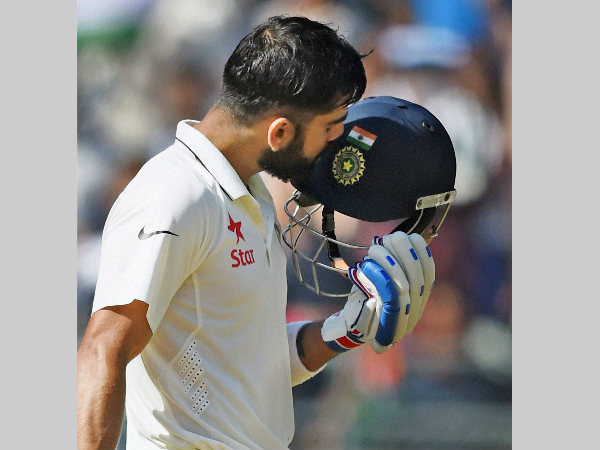 Virat Kohli kisses his helmet after reaching 200 in the 4th Test against England in Mumbai