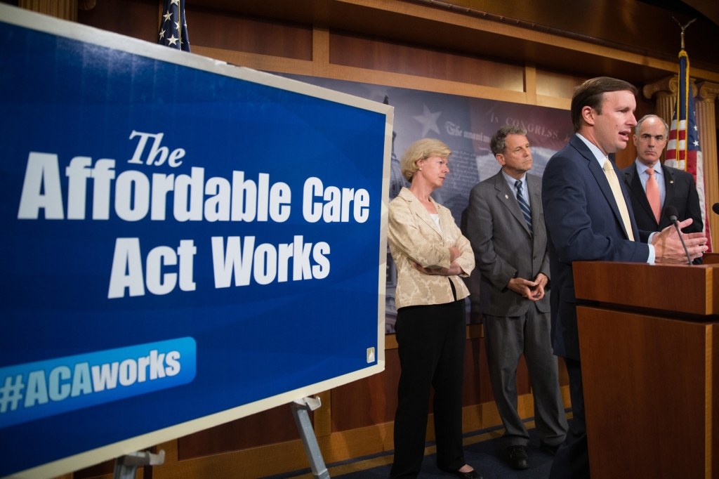 Sen. Chris Murphy D-Conn. left and Sen. Sherrod Brown D-Ohio right attend a press conference on the positive affects of the Affordable Care Act as the Senate convenes for a Sunday session on Capitol Hill in Washington in 2015