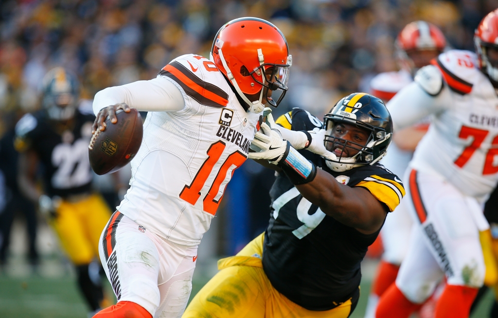 PITTSBURGH PA- JANUARY 01 Robert Griffin III #10 of the Cleveland Browns stiff arms Javon Hargrave #79 of the Pittsburgh Steelers as he scrambles out of the pocket in the second half during the game at Heinz Field