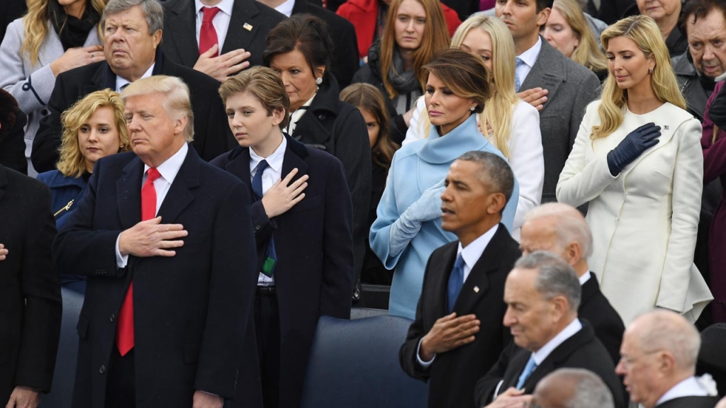 US President Donald Trump and former US President Barack Obama cross their hearts during the National Anthem sung at Trump's swearing-in ceremony