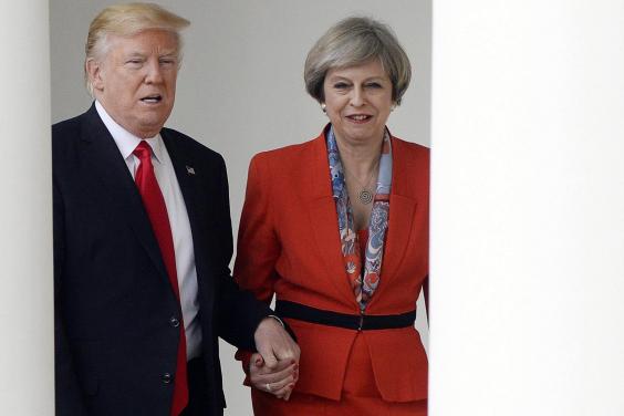 Hand of friendship The US and UK leaders hold hands briefly