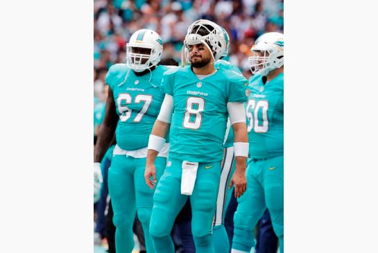 Miami Dolphins quarterback Matt Moore walks the sidelines during the first half of an NFL football game against the New England Patriots Sunday Jan. 1 2017 in Miami Gardens Fla