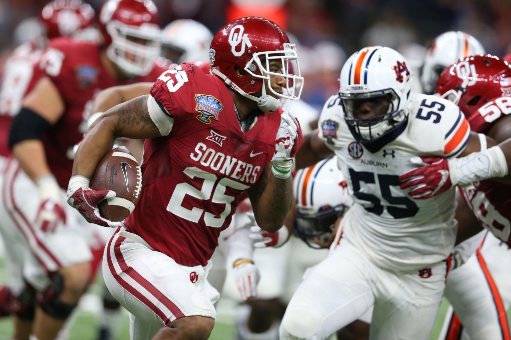 Jan 2 2017 New Orleans, LA USA Oklahoma Sooners running back Joe Mixon runs the ball against Auburn Tigers defensive lineman Carl Lawson in the third quarter of the 2017 Sugar Bowl at the Mercedes Benz Superdome. Mandatory Credit Chuck Coo