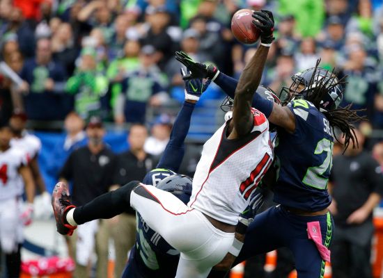 Seattle Seahawks cornerback Richard Sherman breaks up