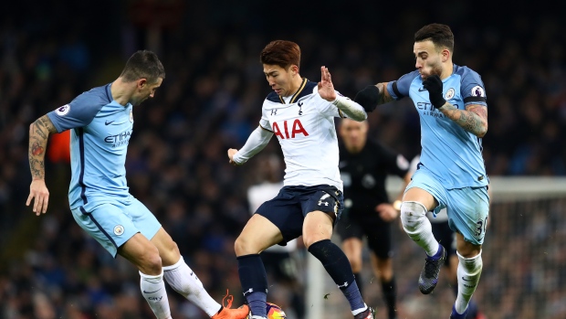 Tottenham's Heung Min Son attempts to pass Aleksander Kolorov left and Nicolas Otamendi of Manchester City right during their 2-2 draw on Saturday in Manchester England