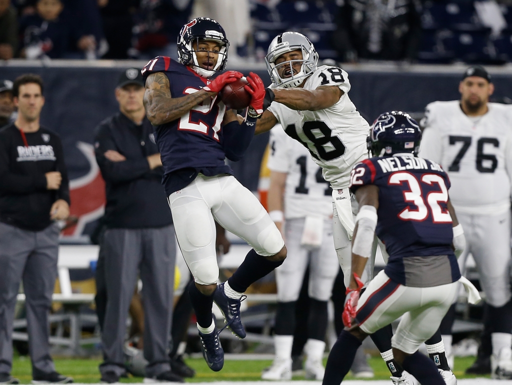 HOUSTON TX- JANUARY 07 A.J. Bouye #21 of the Houston Texans intercepts a pass from Connor Cook #8 of the Oakland Raiders in their AFC Wild Card game at NRG Stadium