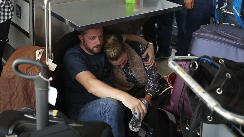 Terrified travellers cower at the Fort Lauderdale Hollywood International airport after a shooting took place near the baggage claim