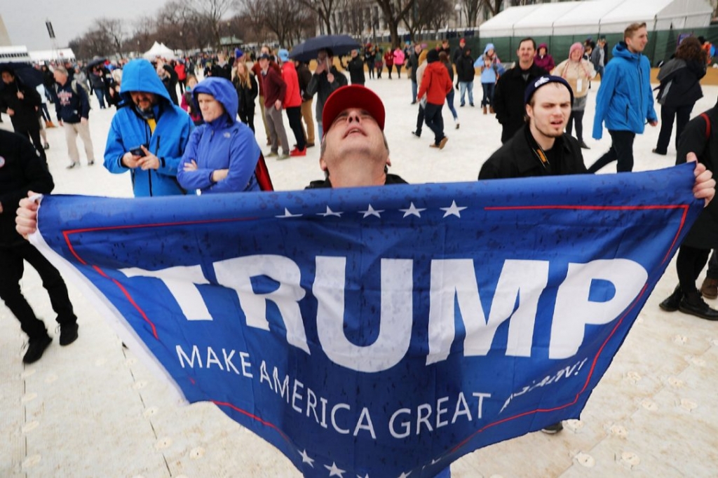 Donald Trump supporters gather for his inauguration on Friday. The president's speech ended with a call to unity through'total allegiance to the United States of America