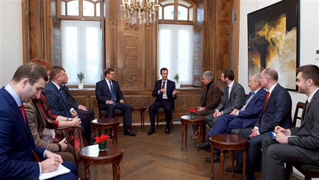 Syrian President Bashar al Assad speaks in a meeting with a delegation comprising Russian and European parliamentarians in Damascus