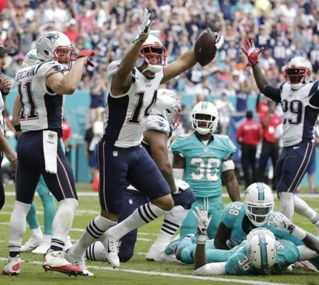 New England Patriots wide receiver Michael Floyd celebrates his touchdown during the first half of an NFL football game against the Miami Dolphins Sunday Jan. 1 2017 in Miami Gardens Fla