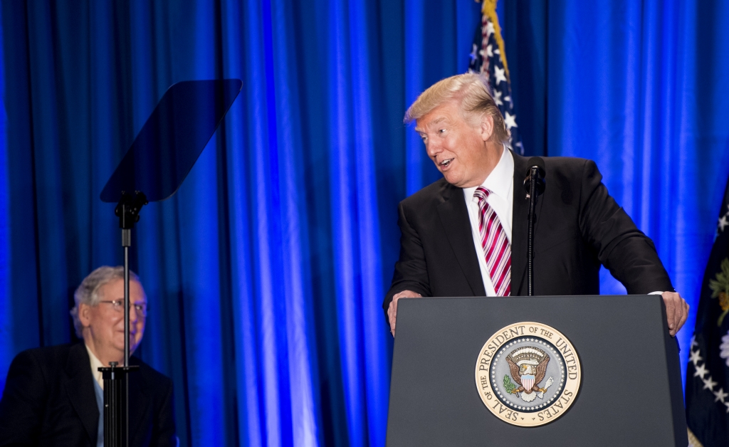 President Donald Trump speaks as Senate Majority Leader Sen. Mitch Mc Connell looks on during the Congress of Tomorrow Republican Member Retreat