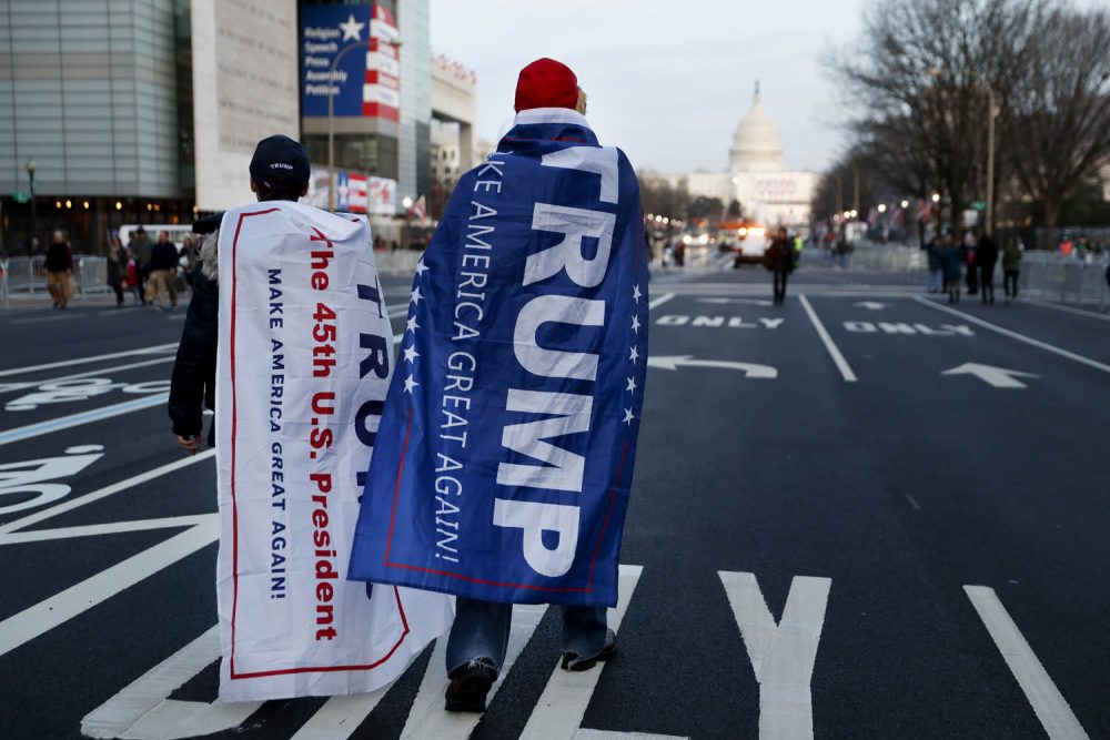 Supporters of President-elect Donald Trump walk along Pennsylvania Avenue Thursday after it was closed down to thru-traffic as security tightens ahead of the presidential inauguration