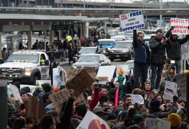 Protesters gather at JFK International Airport's Terminal 4 to demonstrate against President Donald Trump's executive order