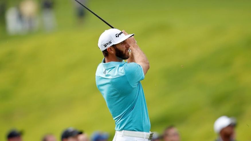 Dustin Johnson watches his approach on the ninth hole during the first round of the Genesis Open golf tournament at Riviera Country Club Thursday Feb. 16 2017 in the Pacific Palisades area of Los Angeles