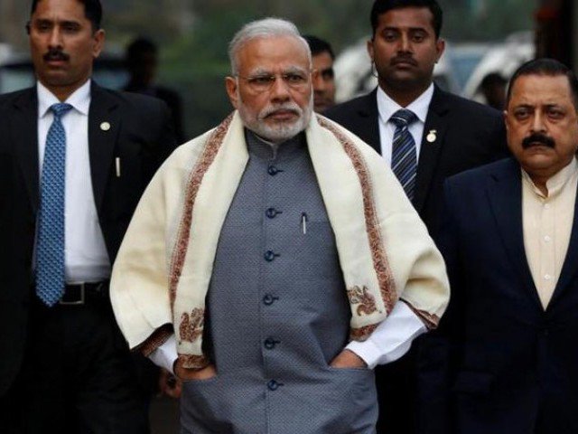 Prime Minister Narendra Modi walks to speak with the media as he arrives at the parliament house to attend the first day of the budget session in New Delhi