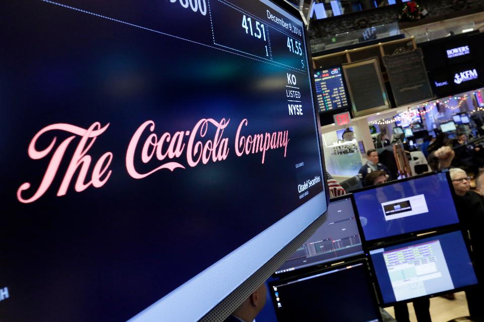 The Coca Cola logo appears above the post where it trades on the floor of the New York Stock Exchange