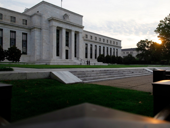 The sun rises to the east of the U.S. Federal Reserve building in Washington