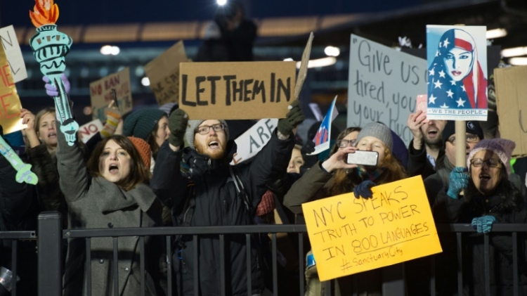 A federal judge's decision to block part of Trump's temporary immigration ban accompanied growing resistance with large protests at major airports across the country