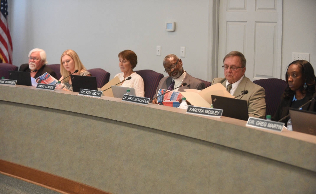 Hamilton County Board of Education members study information packets during their meeting in September