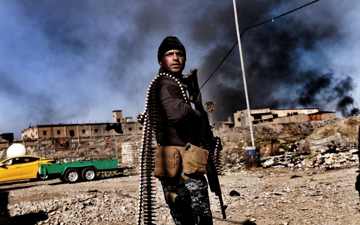 A member of Iraq's elite Rapid Response Division holds position in the northern city of Mosul as they continue the offensive to retake the city's western half from Islamic State