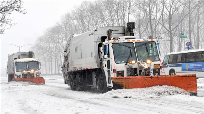 Workers clear the streets from ice and snow in Brooklyn New York