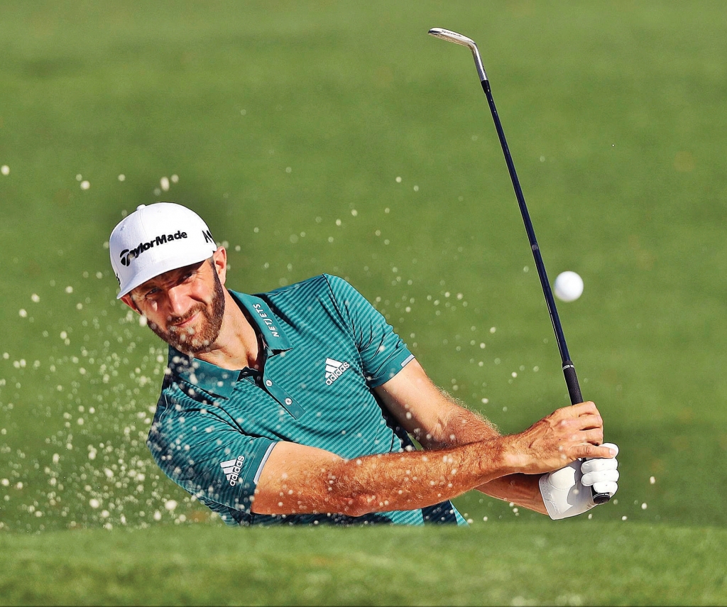 Dustin Johnson hits from a bunker to the second green during a practice round at the Masters on Tuesday