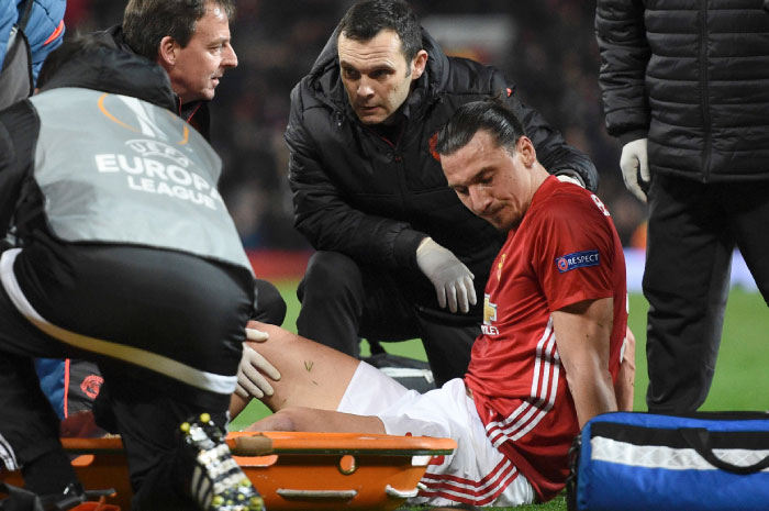 Manchester United’s striker Zlatan Ibrahimovic gets treatment after injuring his knee during the UEFA Europa League quarterfinal match against Anderlecht at Old Trafford in Manchester Thursday. — AFP